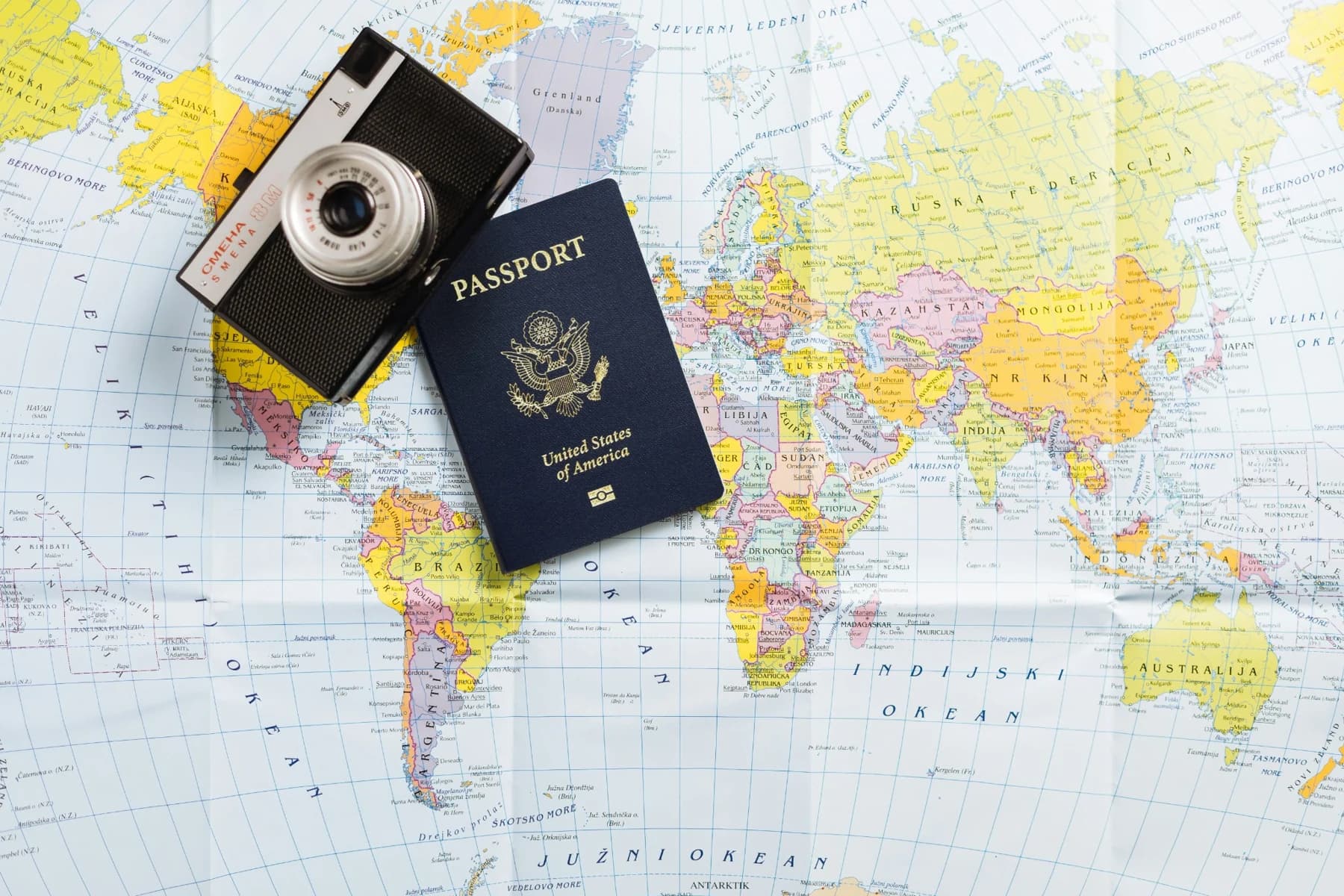 Passport and camera on a world map